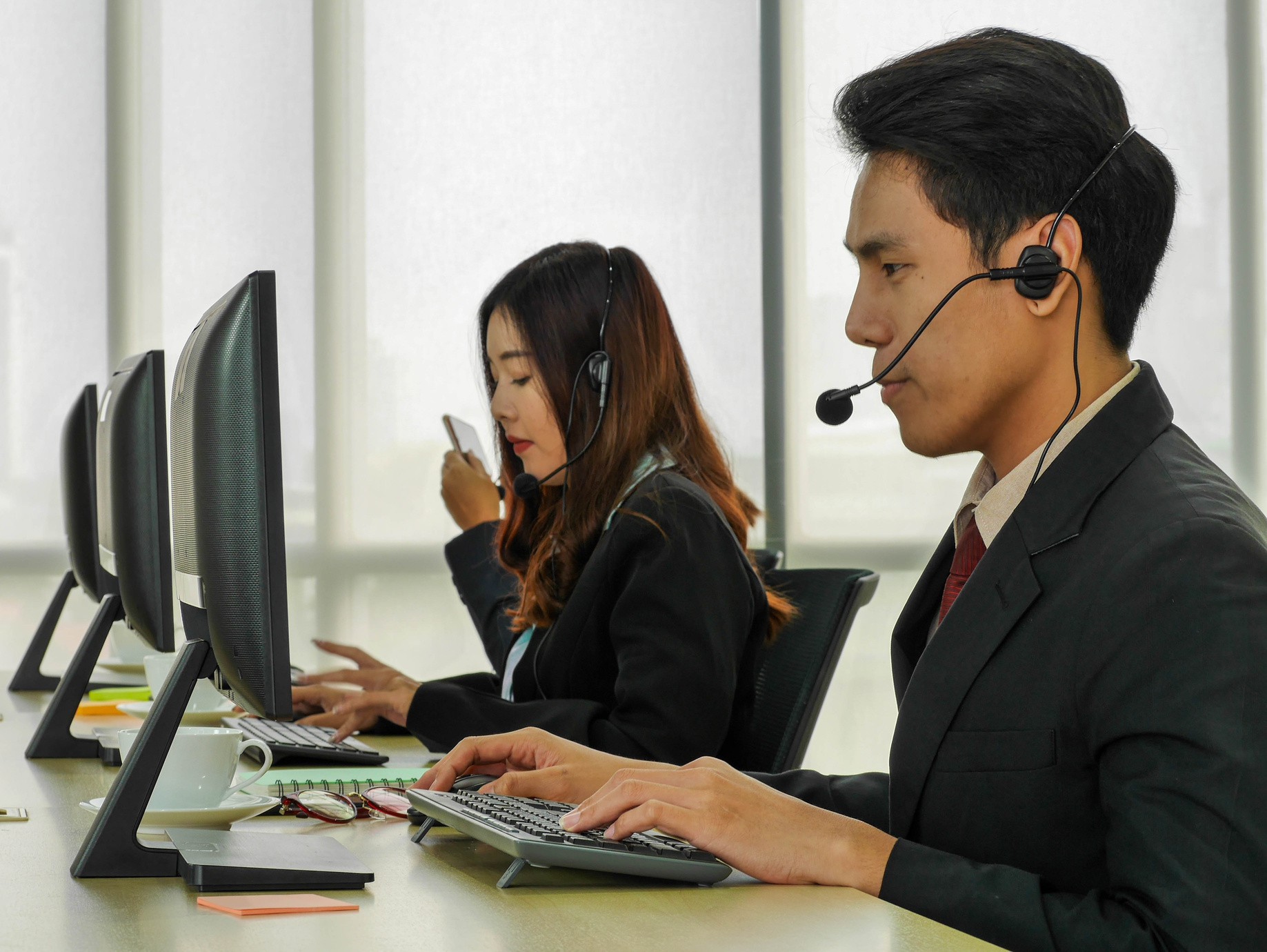 employees at the computer working customer service call center representative